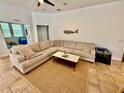 Comfortable living room features a large sectional sofa, neutral tones, and a stylish area rug at 3325 Pintello Ave, New Smyrna Beach, FL 32168