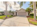 Charming home with a well-manicured lawn and mature trees at 6793 Calistoga Cir, Port Orange, FL 32128