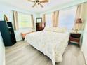 Inviting bedroom with neutral tones, large windows, and cozy decor for a relaxing retreat at 824 Garfish Ave, New Smyrna Beach, FL 32169