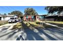 Single story house with a yard and driveway at 131 W Palm Way, Edgewater, FL 32132