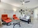 Bright living room with comfy seating, large TV, and access to a balcony at 2 Riverwalk Dr # 302, New Smyrna Beach, FL 32169