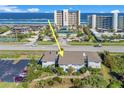 Coastal condo building with lush landscaping offers beach access and community amenities at 4411 Sea Mist Ct # 275, New Smyrna Beach, FL 32169