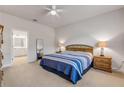 Bright bedroom showcasing a bed with striped bedding, wooden nightstands with lamps, and an ensuite bathroom at 270 Eagle Harbor Way, Daytona Beach, FL 32124