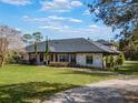 Ranch style home with stone exterior and landscaping at 335 Woodridge Dr, Geneva, FL 32732