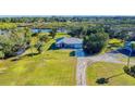 House with waterfront access, large yard, and nearby structures at 977 Bay Dr, New Smyrna Beach, FL 32168