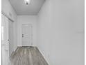 Bright and airy entryway with light gray vinyl plank flooring at 230 Oak Branch Dr, Edgewater, FL 32141