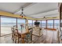 Inviting living room showcasing ocean views, floral sofa, and wood dining set at 4811 Saxon Dr # C102, New Smyrna Beach, FL 32169
