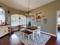 Charming dining room features hardwood floors and a rustic farmhouse table at 6812 Stoneheath Ln, Port Orange, FL 32128