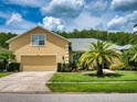 Beautiful two-story home with landscaped yard and attached garage at 6812 Stoneheath Ln, Port Orange, FL 32128