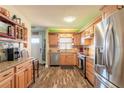 Bright kitchen showcasing wood cabinets, stainless appliances, and a stylish backsplash at 731 Laurel Bay Cir, New Smyrna Beach, FL 32169
