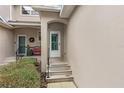 Front entrance with steps leading to a white door at 137 Grey Widgeon Ct, Daytona Beach, FL 32119