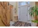 Bright entryway with white door, tile flooring, and potted plant at 1381 S Wembley Cir, Port Orange, FL 32128