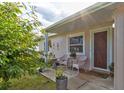 Inviting front porch with white wicker chairs and decorative accents at 144 Ellison Ave, New Smyrna Beach, FL 32168