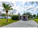 Single story home with a large yard and a driveway at 144 Ellison Ave, New Smyrna Beach, FL 32168