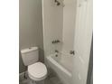 Clean bathroom features a white tiled shower and tub, and updated fixtures at 1500 Wildrose Ln, Daytona Beach, FL 32117