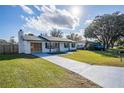 Newly renovated home with a spacious driveway and well-maintained lawn at 18 Wildwood Dr, Edgewater, FL 32132