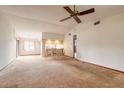 Spacious living room with carpeted floors and a view into the kitchen area at 1820 Sabal Palm Dr, Edgewater, FL 32132