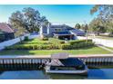 House on the waterfront with a boat and solar panels at 2202 Venetian Ave, Belle Isle, FL 32809