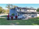 Rear view of house showcasing solar panels and landscaping at 2202 Venetian Ave, Belle Isle, FL 32809