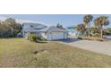 White two-story house with attached garage and grassy yard at 239 Kirkland Rd, New Smyrna Beach, FL 32169