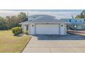 White garage door and driveway of a beach house at 239 Kirkland Rd, New Smyrna Beach, FL 32169