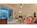 Bright living room with coral sofa and access to balcony at 3 Riverwalk Dr # 302, New Smyrna Beach, FL 32169