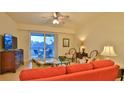 Living room with orange couch and access to balcony at 3 Riverwalk Dr # 302, New Smyrna Beach, FL 32169