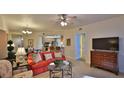 Living area with red couch and view of kitchen at 3 Riverwalk Dr # 302, New Smyrna Beach, FL 32169