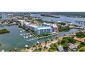 Wide aerial view of waterfront condo building and marina at 3 Riverwalk Dr # 401, New Smyrna Beach, FL 32169