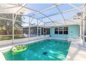 Inviting screened-in pool with a fun inflatable ring at 3015 Queen Palm Dr, Edgewater, FL 32141