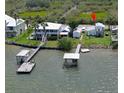 This waterfront home features a private dock and lush landscaping at 303 River Rd, Oak Hill, FL 32759