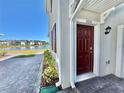 Stylish dark red front door leading to a two-story house at 3035 Meleto Blvd, New Smyrna Beach, FL 32168