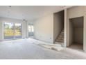 Unfinished room with new drywall, flooring, and sliding glass door at 3046 Isles Way, New Smyrna Beach, FL 32168