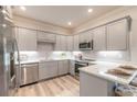 Modern kitchen with stainless steel appliances and gray cabinets at 3066 Isles Way, New Smyrna Beach, FL 32168