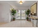 Bright entryway with tile floors and French doors leading to backyard at 3103 Royal Palm Dr, Edgewater, FL 32141