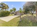 House with a long driveway and lush landscaping at 3103 Royal Palm Dr, Edgewater, FL 32141