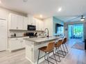 Modern kitchen featuring white cabinets, granite countertops, and an island at 3133 Crab Trap Dr, New Smyrna Beach, FL 32168