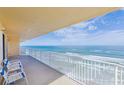 Stunning ocean view from a condo balcony, featuring two chairs at 3145 S Atlantic Ave # 804, Daytona Beach Shores, FL 32118