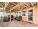 Covered patio with comfortable seating, adjacent to the house at 321 Jessamine Ave, New Smyrna Beach, FL 32169