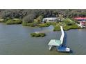 Aerial view of waterfront home with private dock and boat lift at 417 N Riverside Dr, Edgewater, FL 32132