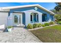 Front entry with walkway, landscaping, and arched entryway at 4367 S Peninsula Dr, Ponce Inlet, FL 32127