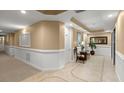 Well-lit hallway with seating area and tile floors at 4628 Harbour Village Blvd # 2206, Ponce Inlet, FL 32127