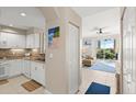 Open kitchen with white cabinets and view to living room at 4628 Harbour Village Blvd # 2206, Ponce Inlet, FL 32127