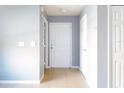 Bright entryway with light gray walls and tile flooring at 526 Mount Olympus Blvd, New Smyrna Beach, FL 32168