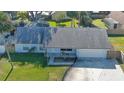 Single-story house with a gray roof, driveway, and grassy yard at 752 Tarry Town Trl, Port Orange, FL 32127