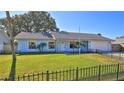 Ranch style home with a light blue exterior and a spacious lawn at 752 Tarry Town Trl, Port Orange, FL 32127