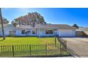 Charming light blue house with a grassy front yard and black fence at 752 Tarry Town Trl, Port Orange, FL 32127