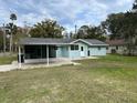 Light blue house with covered patio and spacious backyard at 795 Biro Dr, Port Orange, FL 32129