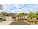 Front view of a charming house with a pink facade at 810 E 9Th Ave, New Smyrna Beach, FL 32169