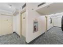 Clean condo hallway with fire extinguisher and neutral decor at 1 Oceans West Blvd # 5A3, Daytona Beach, FL 32118